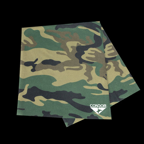 The Condor Multi Wrap in Woodland features green, brown, and black camouflage patterns with a white Condor logo on one corner. This versatile headwear is perfect for outdoor adventures and multiple uses.